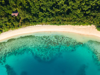 Aerial view of tropical  beach on island Ditaytayan. Beautiful tropical island with white sandy beach, palm trees and green hills. Travel tropical concept. Palawan, Philippines