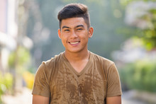 Happy Young Asian Man Smiling In The Streets Outdoors