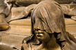 Hooded woman in bronze on sarcophagus