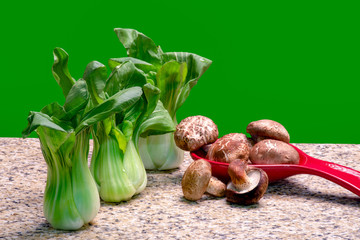 Wall Mural - Bok Choy and mushrooms on marble surface with isolated background.