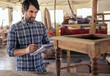 © mavoimages - Craftsman creating a new chair design in his furniture workshop
