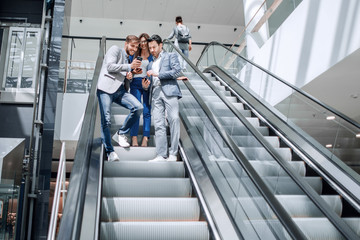 Wall Mural - employees of the company looking at the screens of smartphones