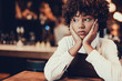 © Yakobchuk Olena - Upset waitress looking aside and touching her cheek by palm
