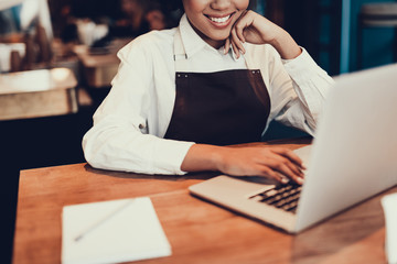 Wall Mural - Attractive woman sitting inside cafe and using netbook