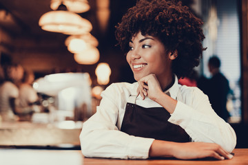 Wall Mural - Pretty waitress woman looking aside and smiling wide