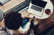 © Yakobchuk Olena - Lady with cup of cappuccino looking at laptop display