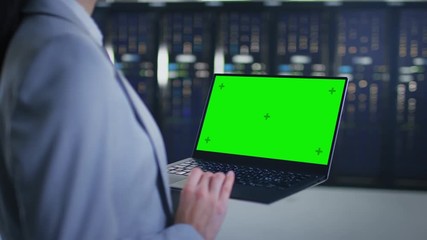 Aufkleber - Close Up Shot of an IT Specialist Working on Laptop with Mock Up Green Screen in Data Center Next to Server Racks. Computer is Running Diagnostics or Doing Maintenance Work.