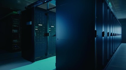 Leinwandbilder - Camera Slide-Trough Shot of a Working Data Center With Rows of Rack Servers. Led Lights Blinking and Computers are Working. Dark Ambient Light.