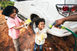 © Rawpixel.com - Boys washing the family car