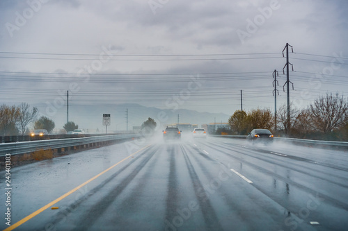 Fotografie, Obraz Driving on the highway on a rainy day with low visibility; wet pavement; south S