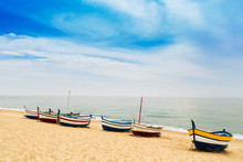 Beautiful Multicolored Wooden Fishing Boats On A Sandy Beach