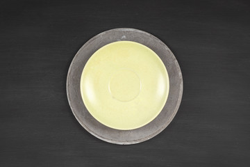 yellow plate on concrete plate on dark  background