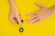 Woman Hands Care. Top View Of Beautiful Smooth Woman's Hands With Professional Nail Care Tools For Manicure On yellow Background. Closeup Of Healthy Female Nails With yellow Nail Polish. High