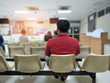 adult man and many people waiting medical and health services to the hospital,patients waiting treatment at the hospital,blurred image of people