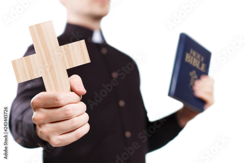 Fotografía Priest holding a cross and the Holy Bible, isolated on white background