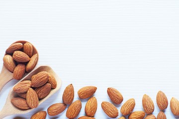 Wall Mural - Almond nut in white on white wooden table background