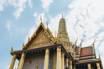 The beauty of the Emerald Buddha Temple . And while the gold of the temple catching the light. This is an important buddhist temple of thailand and a famous tourist destination.