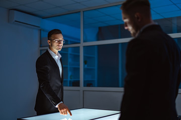 Wall Mural - The two businessmen working with a touchscreen in the office