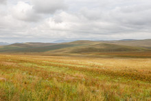 Mongolian Steppe On The Background Of A Cloudy Sky