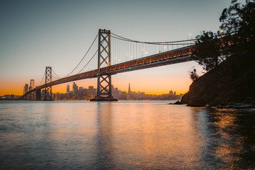 Wall Mural - San Francisco skyline with Oakland Bay Bridge at sunset, California, USA