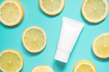 Wall Mural - Natural vitamin c skincare product w/ fresh juicy lemon fruit slices on lime green background. Moisturizing cream, facial foam, body lotion w/ lemon extract. Cosmetic beauty product branding mock-up.