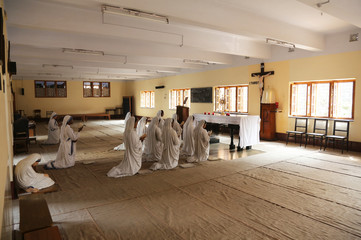 sisters of mother teresa's missionaries of charity in prayer in the chapel of the mother house, kolk