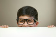 © IndiaPix - Portrait of peeking boy wearing glasses