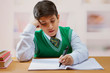© IndiaPix - Young schoolboy doing his writing homework on the table