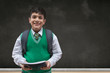 © IndiaPix - Portrait of a smiling school boy holding books and carrying backpack