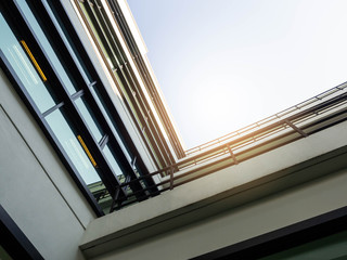 Poster - View of modern glass office building on blue sky background