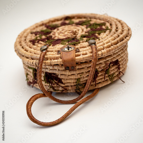 Fotografie, Obraz Straw round straw hat on basket with leather handles