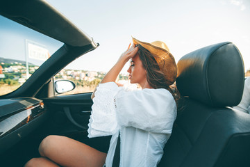 Wall Mural - Young attractive woman driving in cabriolet at seaside