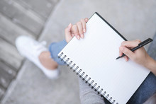 Top View Female Hands With Pen Writing On Notebook Notepad Sitting In Public Park Outdoor. Leave Copy Space  Empty Write A Message.