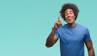 Wall Mural - afro american man over isolated background pointing finger up with successful idea. exited and happy