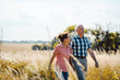 © Kzenon - Senior couple walking down a path in nature on a day in late summer