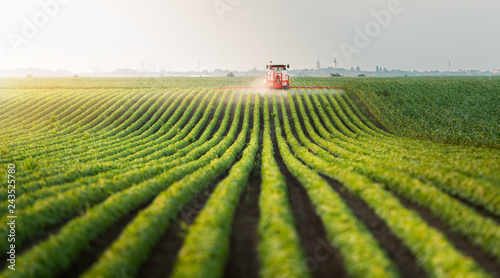 Fotografía Tractor spraying pesticides at soy bean field
