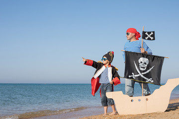 Poster - Father and son playing on the beach at the day time.