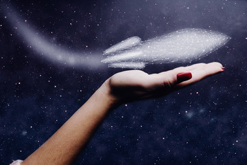 Leinwandbilder - Human hand holding spaceship low poly. Nebula dust. Mixed media.