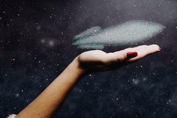 Aufkleber - Human hand holding spaceship low poly. Nebula dust. Mixed media.