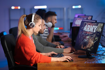 Wall Mural - Young people playing video games at tournament