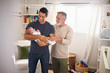 © Monkey Business - Proud senior Hispanic man standing with his adult son holding his four month old boy