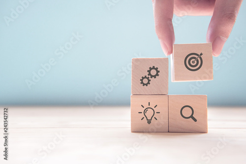 Cuadros en Lienzo Businessman hand arranging wood block with icon business strategy and Action plan, copy space