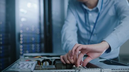 Aufkleber - In the Modern Data Center: IT Engineer Wearing Protective Headphones Installs New Hardware for Server Rack. IT Specialist Doing Maintenance, Running Diagnostics and Updating Hardware.