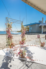 Wall Mural - Event decoration. Wedding chuppa at riverside decorated with fresh flowers. Florist workflow