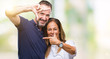 © Krakenimages.com - Middle age hispanic casual couple over isolated background smiling making frame with hands and fingers with happy face. Creativity and photography concept.