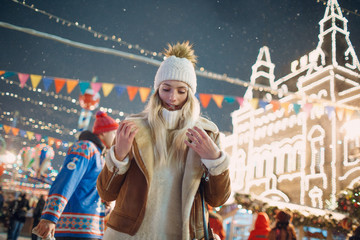 Wall Mural - A young woman walks around the New Year Fair