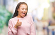 © Krakenimages.com - Young braided hair african american girl wearing sweater over isolated background winking looking at the camera with sexy expression, cheerful and happy face.