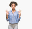 © Krakenimages.com - Young afro american woman over isolated background relax and smiling with eyes closed doing meditation gesture with fingers. Yoga concept.