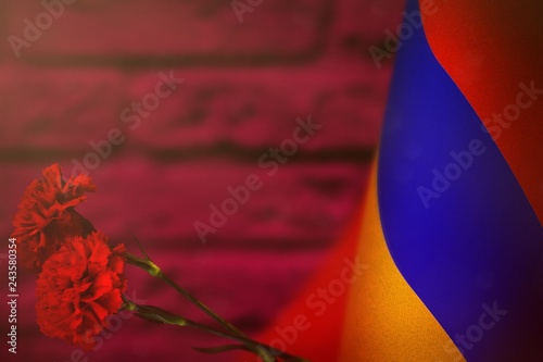 Fotografía Armenia flag for honour of veterans day or memorial day with two red carnation flowers