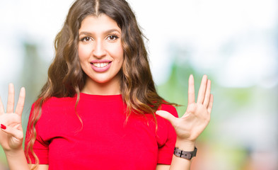 Young beautiful woman wearing casual t-shirt showing and pointing up with fingers number nine while smiling confident and happy.